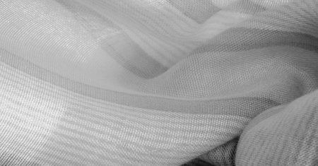 Texture. Background. Monochrome gray silk fabric, a photograph or picture developed or executed in black and white or in varying tones of only one color.の写真素材