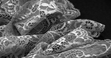 Black lace. Vintage floral background. Lace is an openwork fabric obtained by crossing the threads that form motives connected by the baseの写真素材
