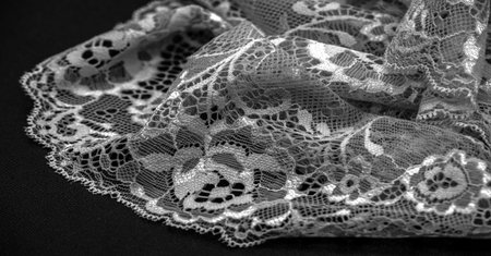 Black lace. Vintage floral background. Lace is an openwork fabric obtained by crossing the threads that form motives connected by the baseの写真素材