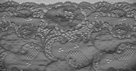 Black lace. Vintage floral background. Lace is an openwork fabric obtained by crossing the threads that form motives connected by the baseの写真素材