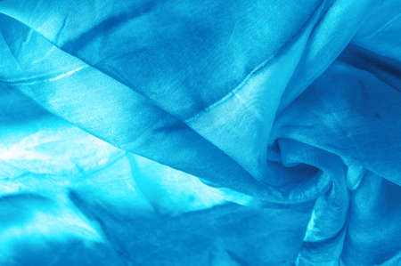 Blue fabric streaked with gray spots on a turquoise background. Abstract designer fabric fancy designer. Beautiful background for your design. Texture. Picture. drawing, pattern, figureの写真素材