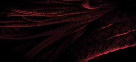 Texture, background, pattern. Fabric in red braids. Knitted knitted background with embossed...