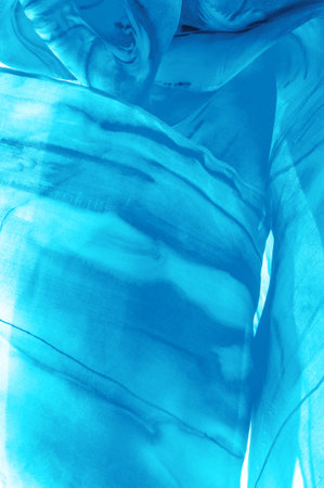 Blue fabric streaked with gray spots on a turquoise background. Abstract designer fabric fancy designer. Beautiful background for your design. Texture. Picture. drawing, pattern, figureの写真素材