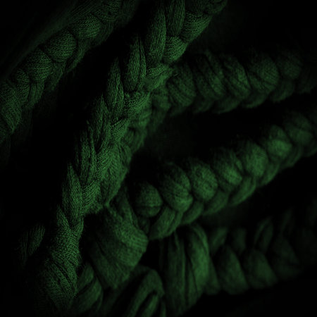 Texture, background, pattern. Fabric in green braids. Knitted knitted background with embossed...