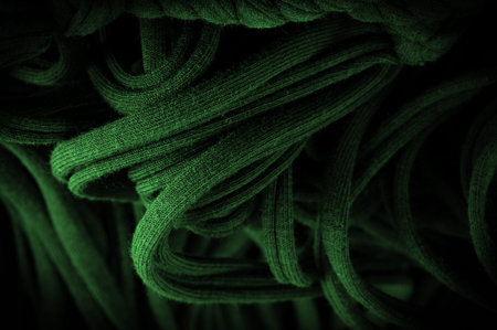 Texture, background, pattern. Fabric in green braids. Knitted knitted background with embossed...