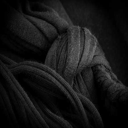 Texture, background, pattern. Fabric in black braids. Knitted knitted background with embossed pattern. Braids in knitting.の写真素材