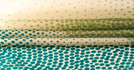 silk fabric. texture or background with cool mint, blue and yellow green polka dot dots on a beige...