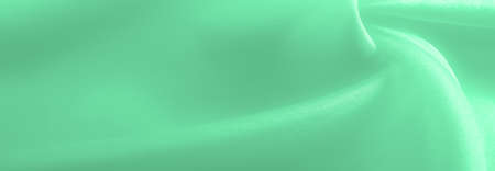 Green pale silk fabric, smooth elegant red silk or luxurious satin fabric, texture as wedding background. Luxury background design. Retro style.の写真素材