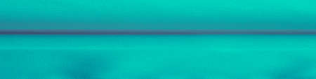 Bright turquoise silk chiffon, fluttering in the wind like a daisy, shines like heaven. Smooth hand of this satin-faced chiffon blends perfectly with your design ideasの写真素材