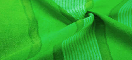 Texture. Background. Silk fabric green fresh color, of the color between blue and yellow in the spectrum; colored like grass or emeralds.の写真素材