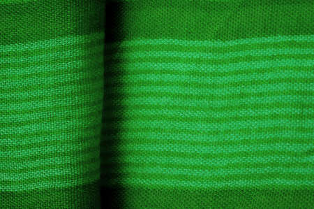 Texture. Background. Silk fabric green fresh color, of the color between blue and yellow in the spectrum; colored like grass or emeralds.の写真素材