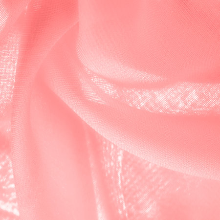 Texture. Background. red pink silk fabric. a fine, strong, soft, lustrous fiber produced by silkworms in making cocoons and collected to make thread and fabric.の写真素材