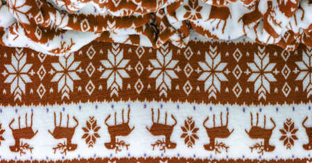 Velvet. Plush. For winter wear. Snow deer, snowflakes. Brown and white tones. Silk fabric with soft, smooth and thick pile. Rich silk clothの写真素材