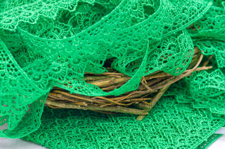 Green lace ribbon. Thick elastic lace ribbon with floral trim for design, craftwork and gift wrappingの写真素材