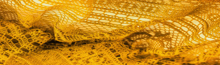 Yellow lace fabric, a thin open fabric, usually of cotton or silk, made using loops, twisting or...
