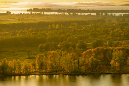 Summer landscape of the river. Sunrise sunset. every day on planet Earth can begin serene with the rising of the sun, when the sky gently brightens over the golden eastern horizon.の写真素材