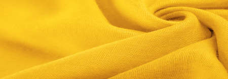 Yellow fine-grained tissue. Velvet texture of yellow silk felt. Texture background. Background fabricの写真素材