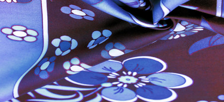 brown-blue fabric with a print of white flowers, geometric lines. Texture, background, pattern