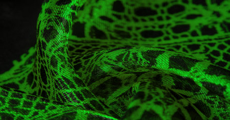 green lace fabric, a combination of green with black fabric. emerald, texture, background, pattern.の写真素材