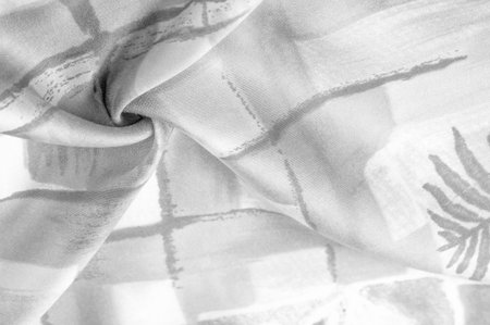 Black and white fabric with an abstract pattern, a print of branches with leaves of flora....