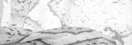gray monochrome fabric with snakeskin pattern, background texture of bright gray fabric close up....