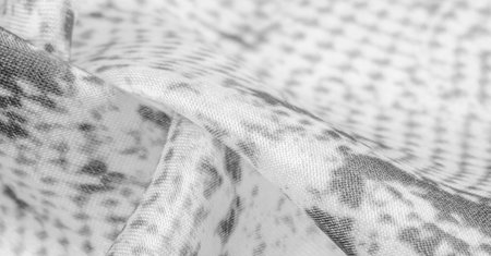 gray monochrome fabric with snakeskin pattern, background texture of bright gray fabric close up....