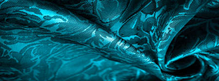 blue silk fabric with a floral pattern, extraordinarily pleasant visual sensations: beautiful appearance, unique shine; embossed pattern, composite textileの写真素材