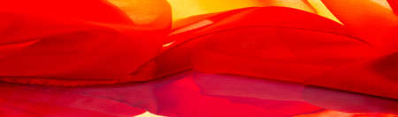 red silk fabric, beautiful smooth elegant, wavy, ruby satin silk luxury fabric, texture background, macro. abstract design. templateの写真素材