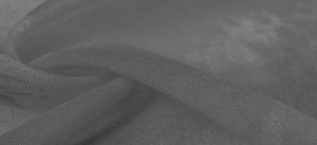 White silk fabric with painted meadow flowers, floral background. Many pale flowers in a colorful composition. Background textureの写真素材