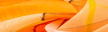 The background texture is an organza pattern - a light transparent fabric of fine knitwear, similar to a veil of fine viscose silk. green white red yellow geometric colorsの写真素材