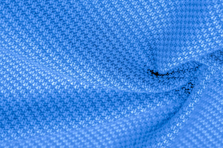 The woolen fabric is blue in color, His super soft and fluffy hand is an open pattern. Background...