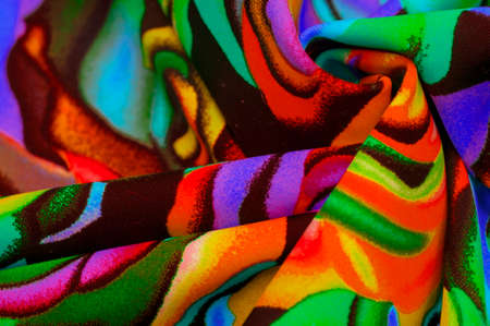 The fabric is bright and colorful, with a pattern of roses all over the fabric, stylized as watercolor paints.の写真素材