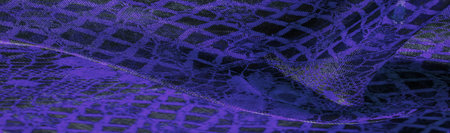 Texture, background, pattern. Sapphire blue lace fabric, a combination of blue with black fabric....