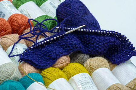 blue yarn and knitting. against the background of yarn with woolen thread of different colors, 19,...