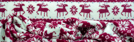 Velvet. Plush. For winter wear. Snow deer, snowflakes. Red and white tones. Silk fabric with soft, smooth and thick pile. Rich silk clothの写真素材