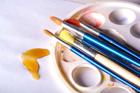 The artist paints with brushes. easel. watercolor. White background. The one who creatively works in an. field of art.の写真素材