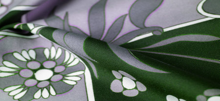 Green blue fabric with print of white flowers, geometric lines. Introduces a new modern color...