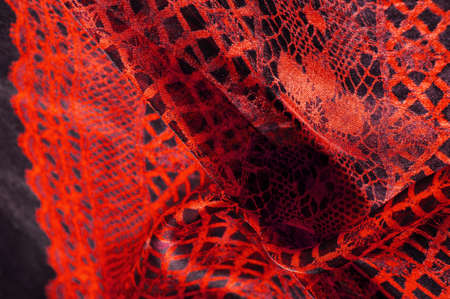 red background from textile material. lace fabric. Natural ruby texture. Texture, background, pattern.の写真素材