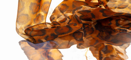 Light fine silk fabric, cheetah skin, brown. African savanna theme. Background texture, patternの写真素材