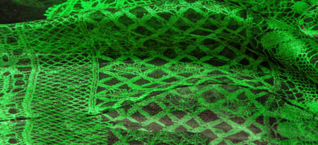 green lace fabric, a combination of green with black fabric. emerald, texture, background, pattern.の写真素材
