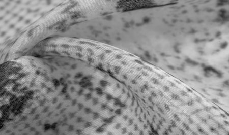 gray monochrome fabric with snakeskin pattern, background texture of bright gray fabric close up....
