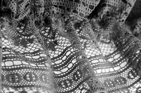 Background, texture, pattern, black lace fabric, thin open fabric, usually made of cotton or silk, made using loops, twisting or knitting threads in patternsの写真素材