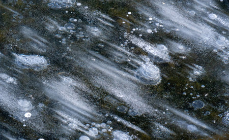 There is frost on the street, ice on the river, ice bubbles stuck in ice, unusually colorful ice...