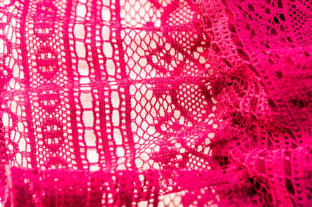 red lace fabric, red lace patterned with flower shape on a white background. background texture, pattern.の写真素材