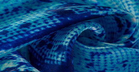 blue fabric with snakeskin pattern, background texture of bright blue fabric close up. background, texture, patternの写真素材