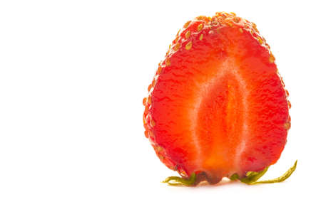 Photo of berries. a ripe strawberry cutted in half isolated over a white bachgroundの写真素材