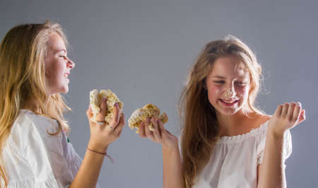 studio photography, portrait of girls 14 years old, girls playing in the studio with cakeの写真素材
