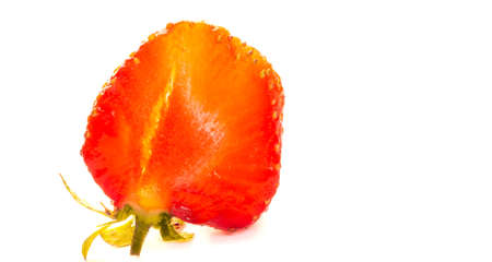 Photo of berries. a ripe strawberry cutted in half isolated over a white bachgroundの写真素材