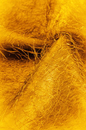 Brown yellow silk fabric, woven threads on the fabric, fluffy effect. Background texture, decorative ornamentの写真素材