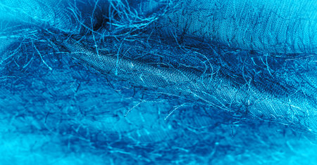 Blue silk fabric, woven threads on fabric, fluffy effect. Background texture, decorative ornament